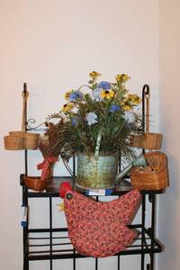 lot 114 image: Hen Basket, small Baskets, and Watering Can Flower Arrangement