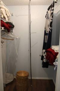 lot 147 image: Closet Contents Dallas Cowboys Blanket, Towels, Floor to Ceiling Hanging Rack, Basket Laundry Bin, Copper Fit Belt, and Garment Cover
