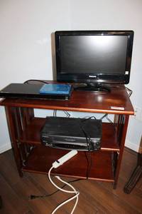 lot 158 image: 29W x 19D 24H Mission Style Table, Phillips TV, Sony Blu-ray Player with Movie, and Broksonic VHS Player