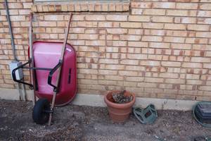 lot 257 image: Wheelbarrow and Plastic Planter