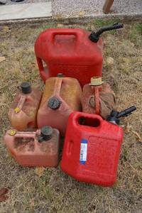lot 246 image: Red Plastic Gas Cans - largest is 5 Gal.