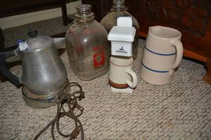 lot 123 image: Cast Iron Coffee Pot, Vintage Gallon Milk Bottles, Marshall Pottery Pitcher, and Express One Mug Coffee Maker