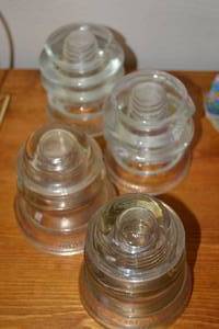 lot 145 image: Set of 4 Hemingray and Whitall Telephone Pole Insulators