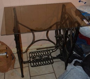 lot 306 image: Glass Top Table with Cast Iron Sewing Machine Base 30W x 19D x 29H