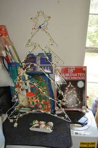 lot 376 image: Christmas Lot Cast Iron Door Stop, Door Mats, Illuminated Wire Christmas Trees, and Wrapping Paper