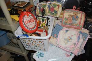 lot 429 image: Cast Iron Trivets, Coca-Cola Dish Towels and Hot Pads, Placemats and More