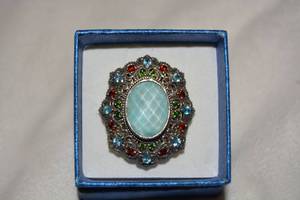 lot 612 image: Sterling Silver and faceted blue ocean quartz cabochon statement ring. Large size accented with Blue Topaz and garnet rounds. Gems tested. High filigree table. Size 9