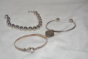 lot 594 image: (3) Sterling Silver bracelets. All marked 925. Bracelet with heart locket marked 925 Italy.