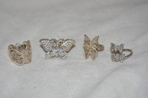 lot 601 image: (4) Sterling Silver rings with butterfly motif. All marked 925. By pass ring marked 925 Karis. Sizes 8, (2)-9 and 10.5