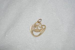 lot 652 image: 14K yellow gold #1 Dallas Cowboys pendant. Approx. .50H. Marked 14K.