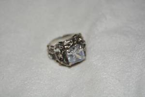 lot 654 image: Sterling Silver Ring with clear stone and twisted branch design. Marked 925. Size 9