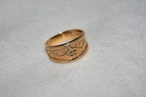 lot 657 image: 10K yellow gold ring with floral design and rope border. Marked 10K AAJ. Size 8