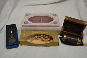 lot 649 image: Pink Jewelry Box with glass top, Sarah Coventry vintage aurora borealis statement broochpin in original box, crystal LED light keychain and brass and leather bound collapsible telescope in decorative box with inlaid brass anchor motif.
