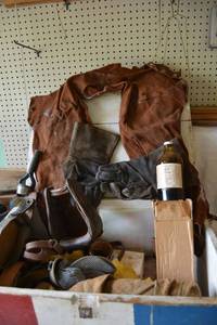 lot 499 image: Red, White and Blue Box with Horse Riding Leather Gear, Stirrups, Welding Sleeve, Leather Dye, and More