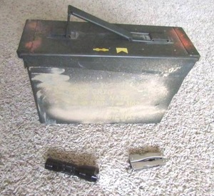 lot 102 image: Military ammunition cannister, mini LED flashlight, mini multitool