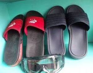 lot 47 image: Mens size 12 Slides Nike in style and color as shown and safety goggles