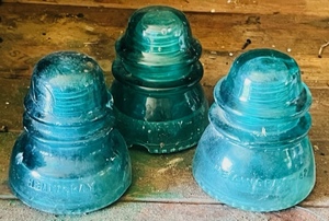 lot 13 image: Three Green Hemingray Glass Insolators