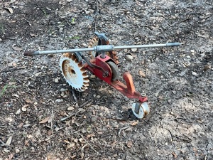 lot 177 image: Vintage Red &amp White Cast Iron Thompson Traveling Lawn Sprinkler Tractor