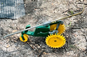 lot 180 image: Vintage Green &amp Yellow Cast Iron Crestline Pathfinder Traveling Lawn Sprinkler Tractor