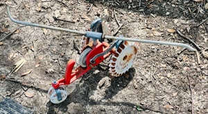 lot 181 image: Vintage Red &amp White Cast Iron Thompson Traveling Lawn Sprinkler Tractor