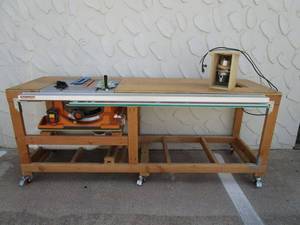 lot 1 image: WORKBENCH W RIGID 10 TABLE SAW MODEL #R4510, CRAFTSMAN ROUTER & GUIDE RAILS INSTALLED, EVERYTHING WORKS GREAT