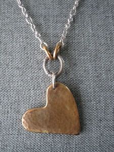 lot 13 image: JAMES AVERY 925 SILVER & BRONZE, RETIRED BRONZE FEARLESS HEART & 30 OVAL TWIST CHANGEABLE CHARM NECKLACE