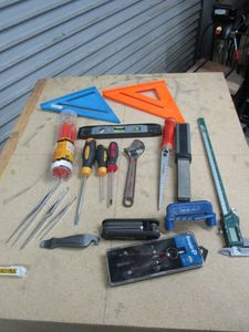 lot 238 image: EMPIRE COMPASS, ROCKLER CENTER LINE MARKING TOOL, ALLEN WRENCHES, LINE LEVEL, ADJUSTABLE WRENCH, SCREW DRIVERS, STANLEY DRYWALL SAW, SMITHS KNIFE SHARPENER, CALIPER, MAGNETIC TORPEDO LEVEL, PENCILS, EMPIRE & SWANSON SPEED SQUARES