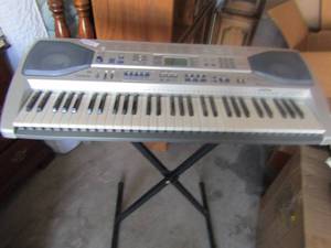 lot 64 image: Casio smart keyboard with built in speakers  charger not found, comes with black metal piano stand