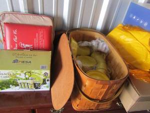 lot 44 image: Delaware picnic caddy and Wicker picnic basket with a yellow set of dishes, plates, bowls, plastic, and more�