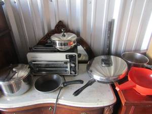 lot 48 image: Hamilton beach toaster oven, orange handeled strainer, covered pot and a covered skillet pan