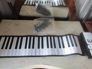 lot 58 image: Play and roll piano with microphone  has own carrying case