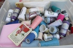lot 136 image: Tote full of sewing threads,  cloth,  zippers,