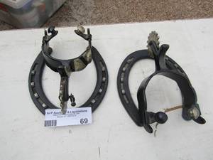 lot 69 image: 2 metal spurs with horseshoe stands