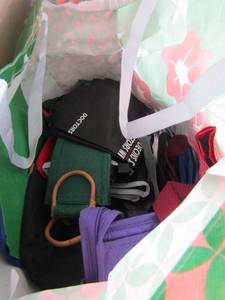 lot 173 image: box full of reusable grocery bags, traveling bags, make up bags, and more