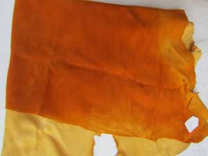 lot 270 image: orange piece of raw leather  hide