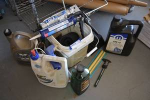 lot 411 image: Roundup Spray, Tiki Torch Citronella Fuel, Caulking Guns, Digital Caliper, and Transmission Fluid and More