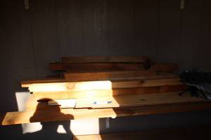 lot 693 image: Wood 4x4 Stakes, 1x8, and Ones mounted on wall