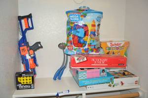 lot 57 image: Pictionary Junior, Twister Hopscotch, Tea Set, Shapes Puzzles, Lego Creationary, and Nerf Shooters