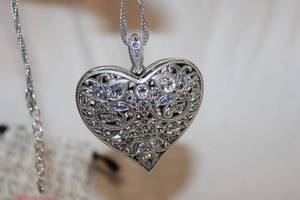lot 736 image: Jewelry Signed Brighton Necklace. Crystal filigree large heart pendant. Heart shaped clasp with Brighton B hang tag.