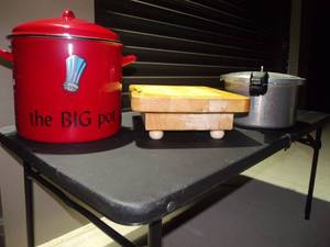 lot 17 image: Red StockPasta Pot with Lid, Appears Unused. Cutting board on Feet and Pressure Cooker with Owners Manual