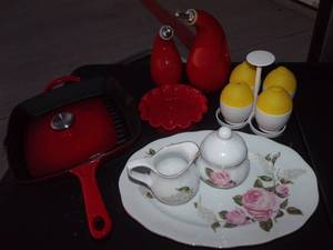 lot 40 image: China Pink Rose Pattern Platter with Matching Creamer & Sugar, Red Cast Iron Skillet and Press, Vintage Red Oil & Vinegar Cruets Microwave Egg Cooker