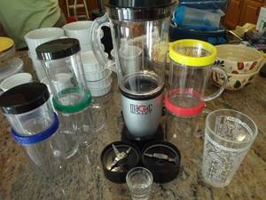 lot 55 image: Magic Bullet, 3 Different blade attachments, blender jars, and mugs, comes with colorful rim pieces