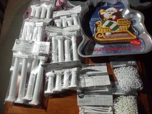 lot 108 image: New Wilton Cake Supplies, Santa in Sleigh Cake Pan, Pillars for Multiple Layered Cakes, Plastic Pegs, and Pearls