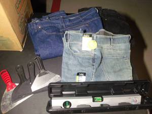 lot 215 image: Mens Pants size 44x34, straight edge scrapers, and laser level in plastic case.  See pictures