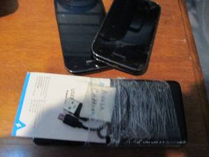 lot 105 image: Two Samsung SII Cellphones and Portable Battery Pack