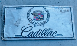 lot 59 image: Silver Cadillac Wreath Aluminum License Plate - Still in Plastic