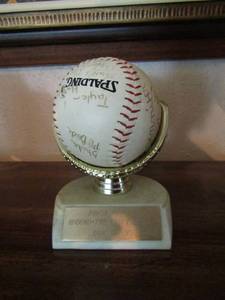 lot 70 image: Around the clock grill softball trophy, signed by multiple people shows in the picture. Has a glove ball stand