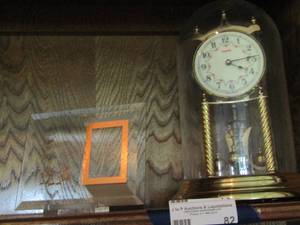 lot 82 image: Kundu clock with glass cover, grandma clear glass picture frame says to grandma with love