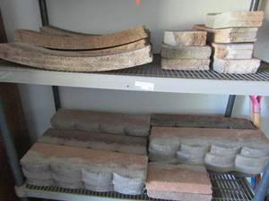 lot 108 image: Lot of concrete gardening stones to edge out your flower bed qty approx. 25 pieces mixed