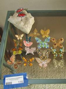 lot 116 image: crystal rock with red butterfly sitting on top, 16 butterfly pendants various sizes and colors. Very beautiful pieces